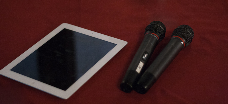 A tablet and two microphones on a table